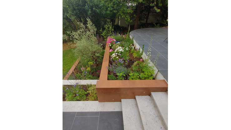 Hard landscaping project with paved patio and retaining walls