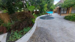 Hard landscaping project with paved patio and retaining walls