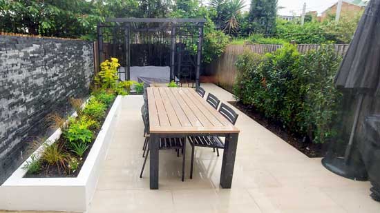 Hard landscaping project with paved patio and retaining walls